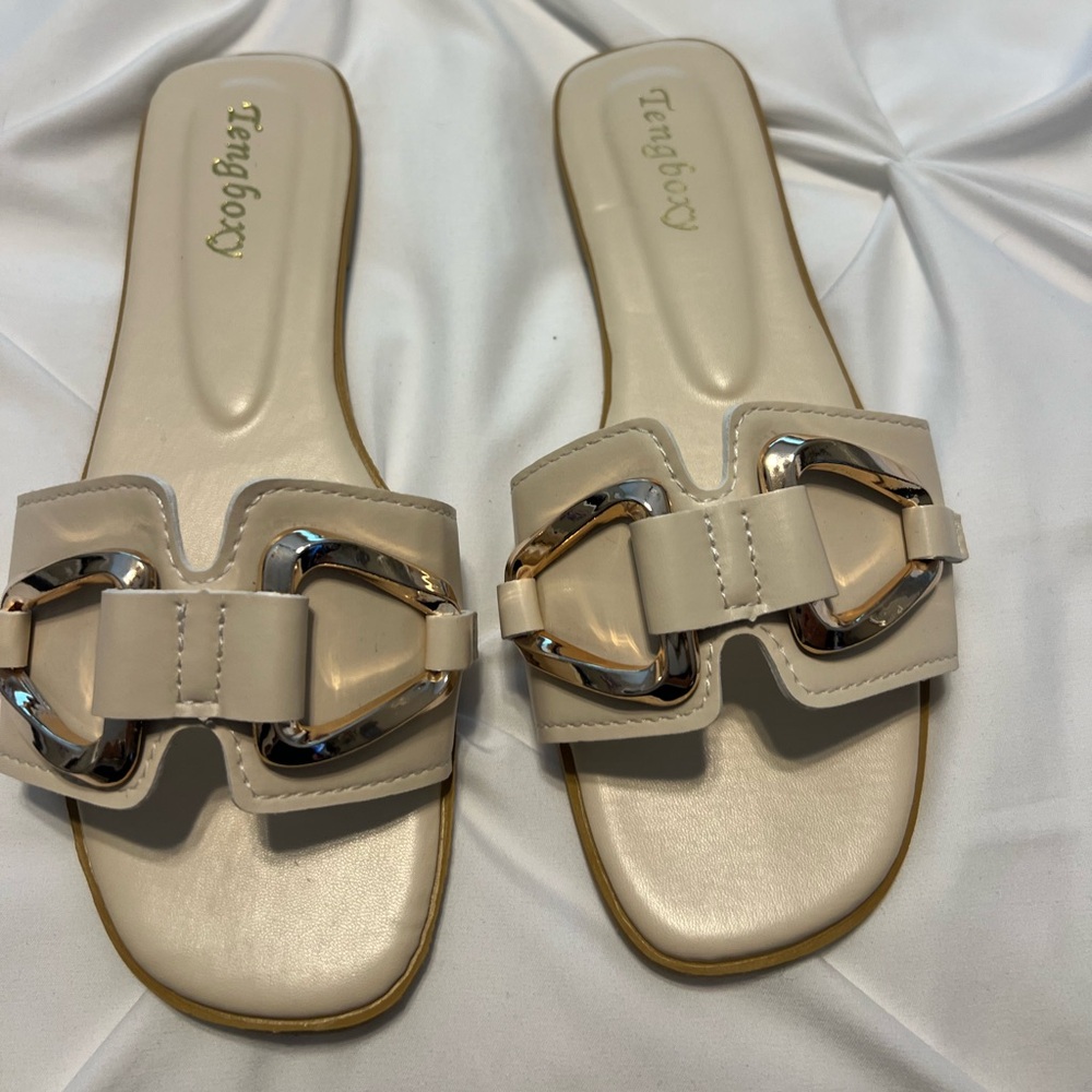 Neutral colored slides with metal detail. Worn once. Size 39.